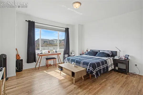 a bedroom with a bed and a large window