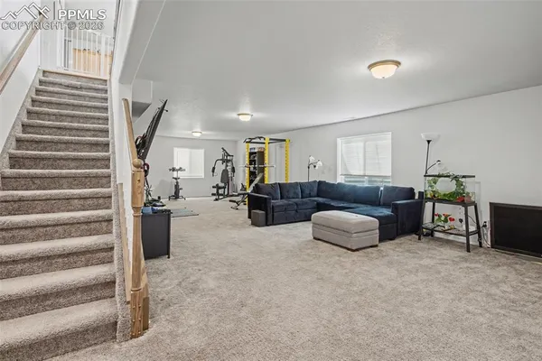 a living room with furniture and a painting on the wall