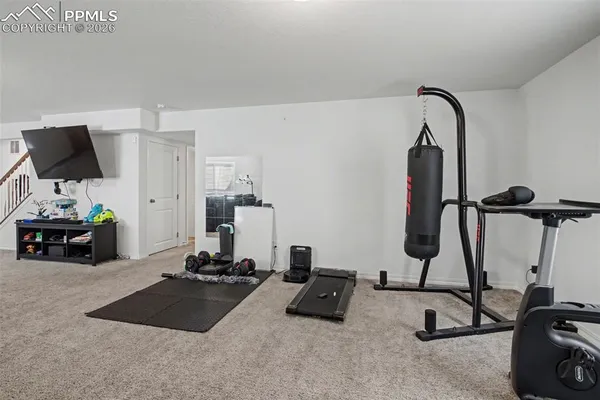 a room with gym equipment and a mirror