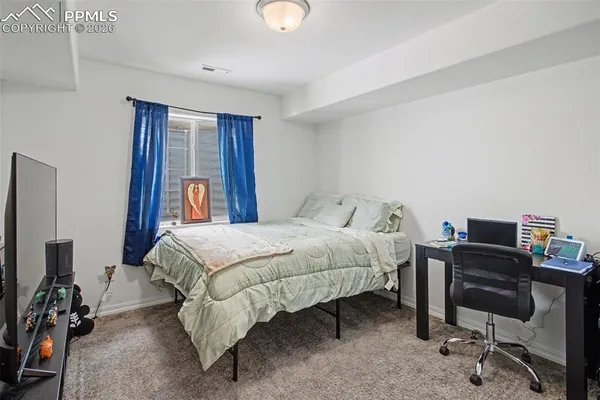 a bed room with a bed and a desk