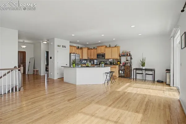 a view of kitchen with kitchen island dining table and chairs