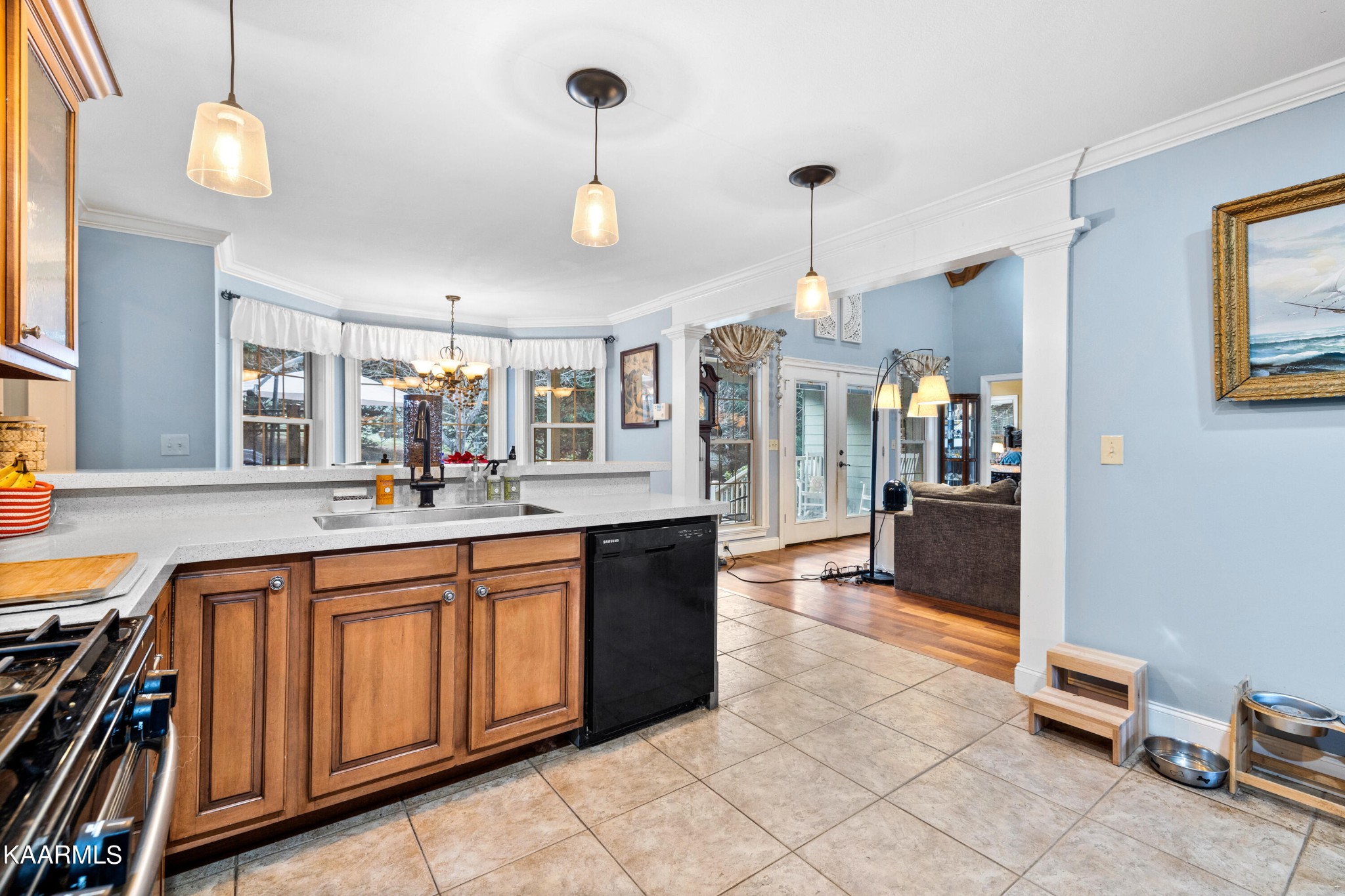 1142 Denton Road Sevierville, TN 37862 - Photo 4 of 28 a large kitchen with kitchen island granite countertop a stove a sink a refrigerator and a dining table with wooden floor