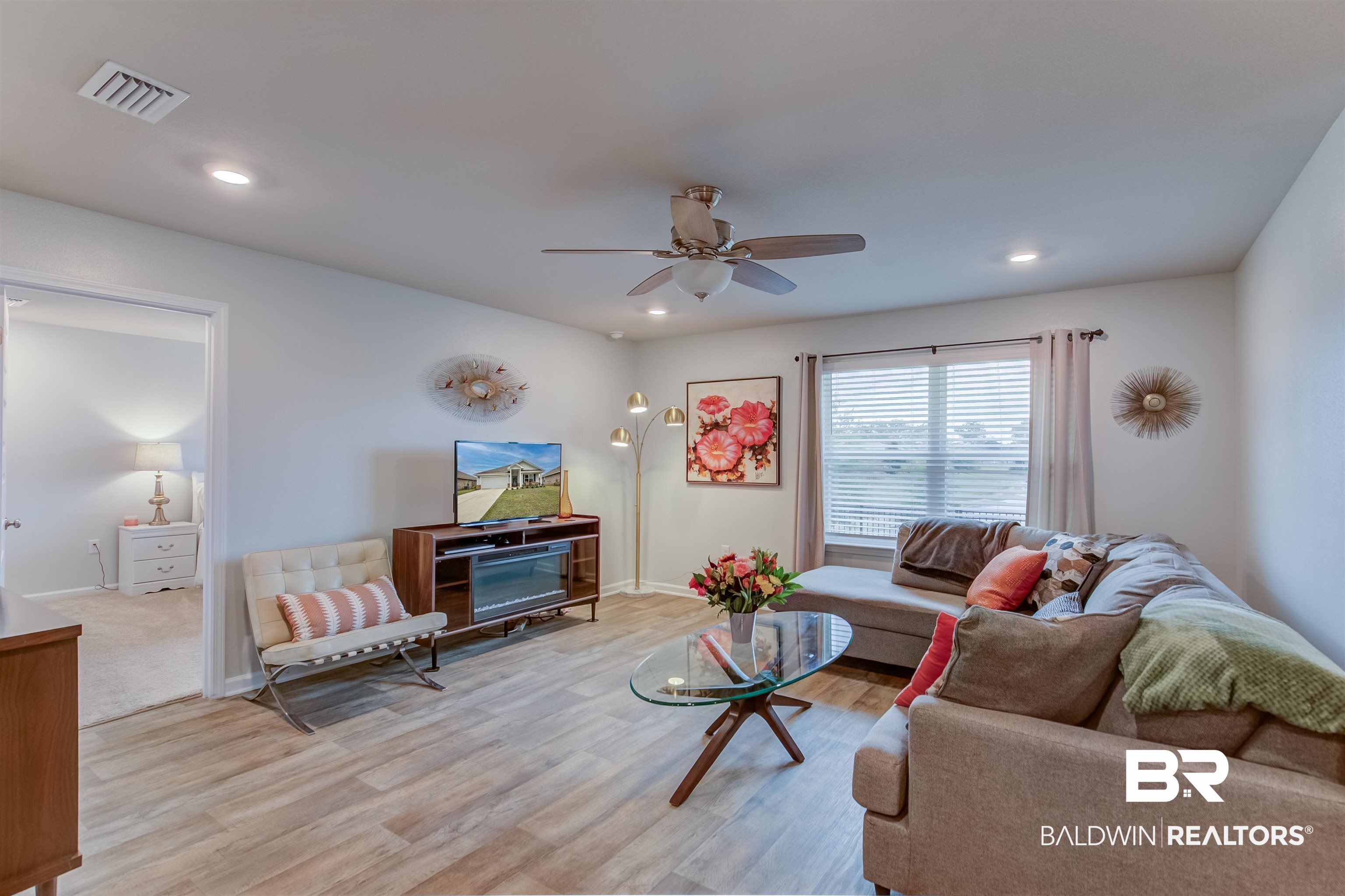 8033 Irwin Loop Daphne, AL 36526 - Photo 11 of 38 Living area featuring wood-finish flooring, recessed lighting, and a ceiling fan