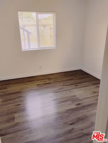 a view of a room with wooden floor and window