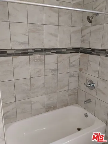 a bathroom with a bathtub and shower