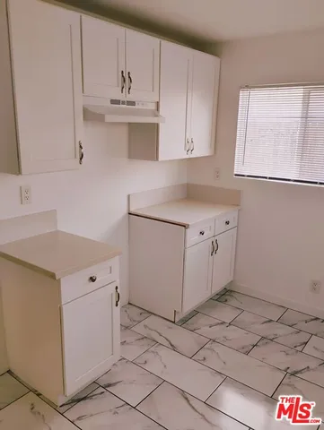 a kitchen with cabinets and window