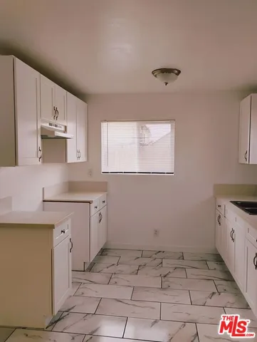 a kitchen with a stove a sink and a refrigerator