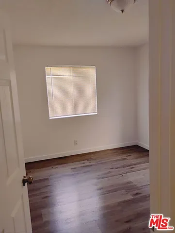 a view of an empty room and wooden floor