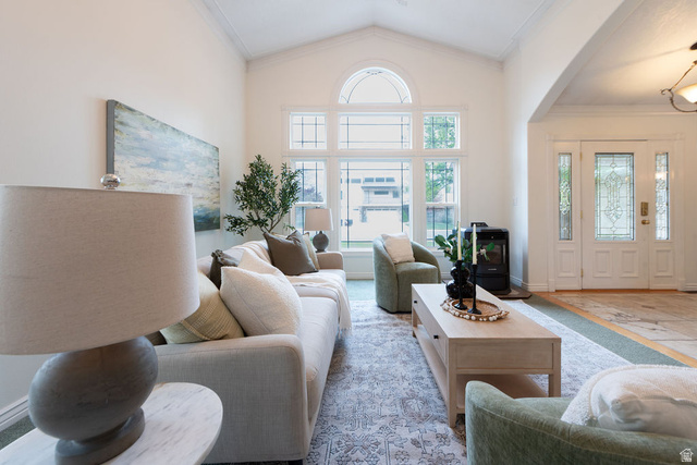 875 East 1300th Street North Mapleton, UT 84664 - Photo 17 of 65 Living area with healthy amount of natural light, arched walkways, crown molding, and a high ceiling