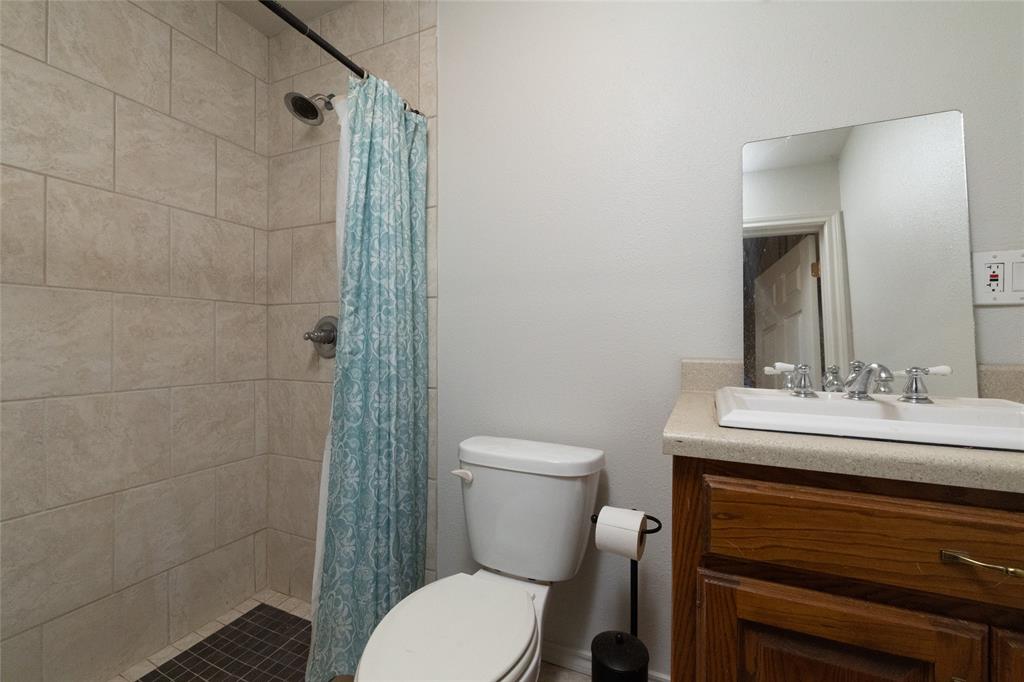 405 Kimbrough Road Azle, TX 76020 - Photo 33 of 39 a bathroom with a sink a toilet and shower