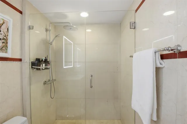 a bathroom with a shower and a glass door
