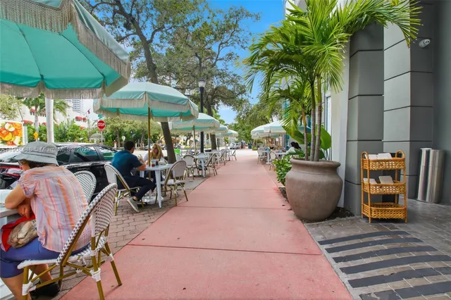 an outdoor space with patio and white umbrellas