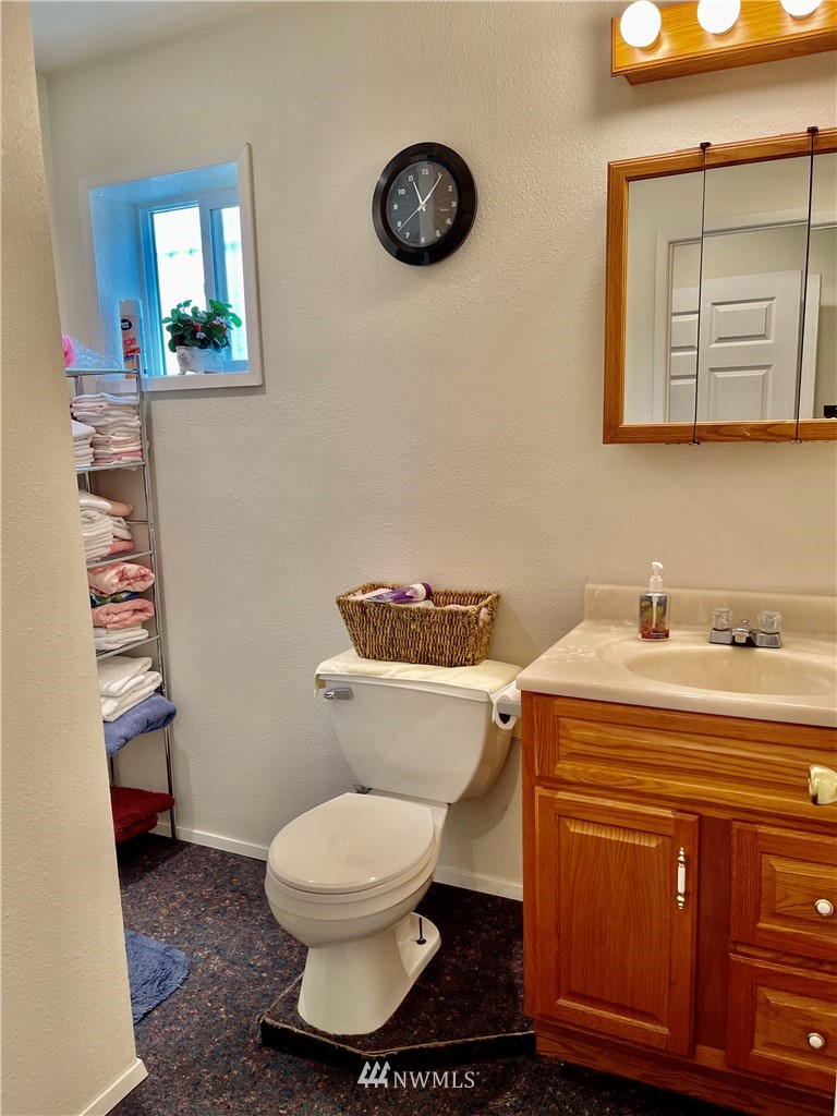 19229 Patterson Road East Orting, WA 98360 - Photo 15 of 35 a bathroom with a toilet a sink and mirror