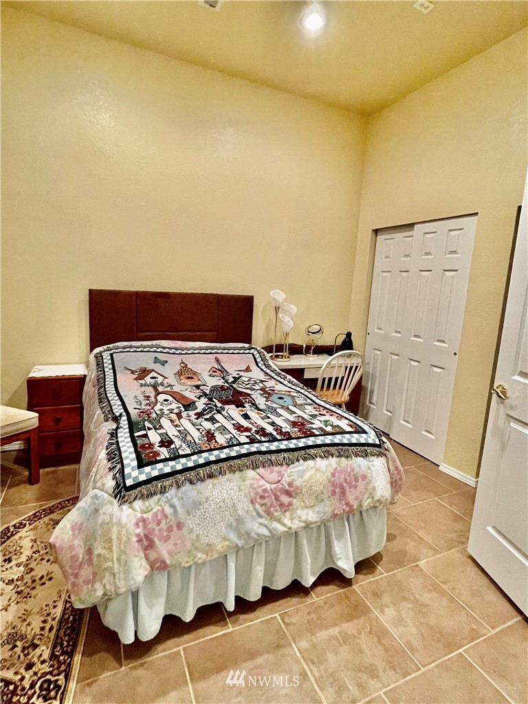 19229 Patterson Road East Orting, WA 98360 - Photo 23 of 35 a bed sitting in a bedroom next to a window