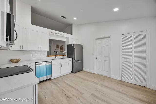 a kitchen with a sink a stove and refrigerator