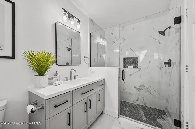 a kitchen with a sink cabinets and wooden floor