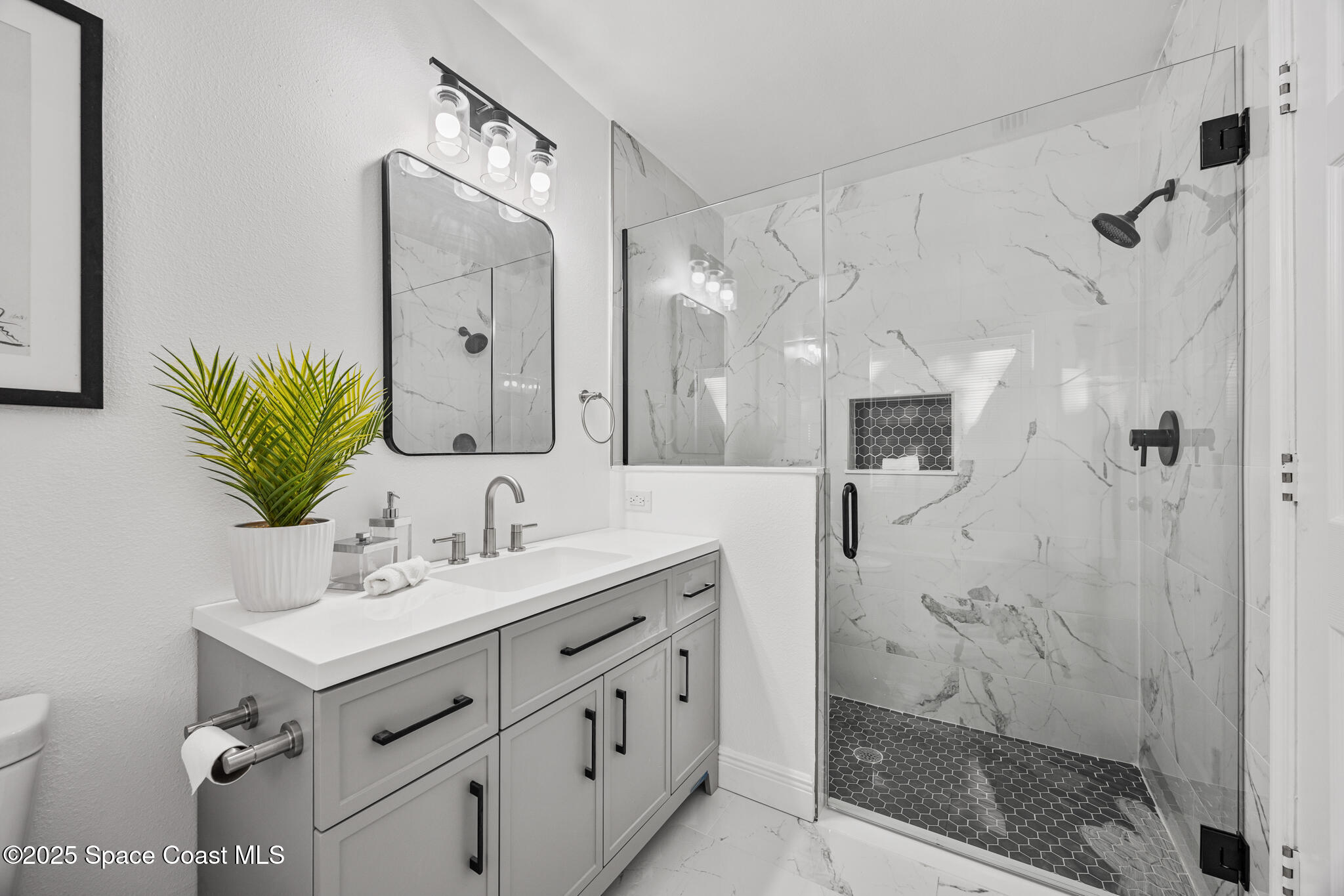 3568 Egret Drive Melbourne, FL 32901 - Photo 11 of 27 a bathroom with a double vanity sink mirror and shower