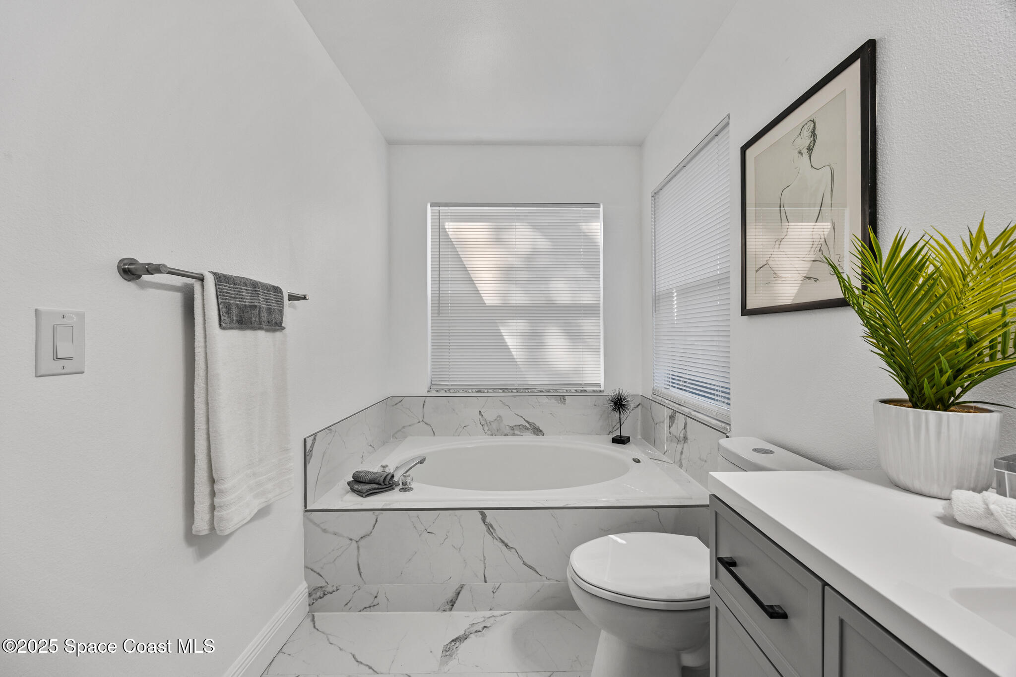 3568 Egret Drive Melbourne, FL 32901 - Photo 12 of 27 a bathroom with a sink toilet and shower