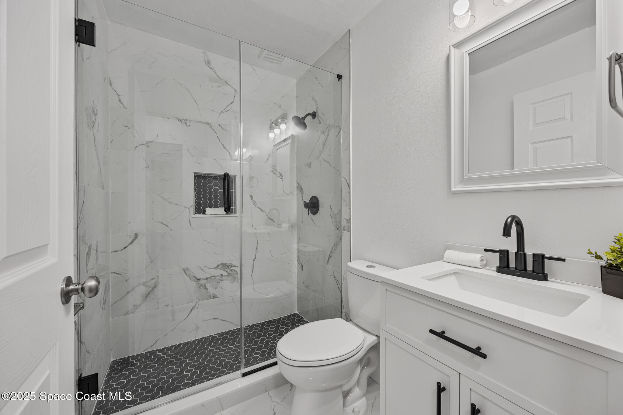 3568 Egret Drive Melbourne, FL 32901 - Photo 16 of 27 a bathroom with a sink toilet and shower