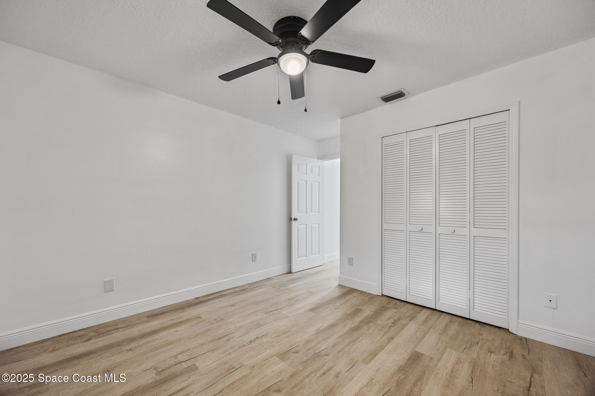 3568 Egret Drive Melbourne, FL 32901 - Photo 17 of 27 wooden floor in an empty room