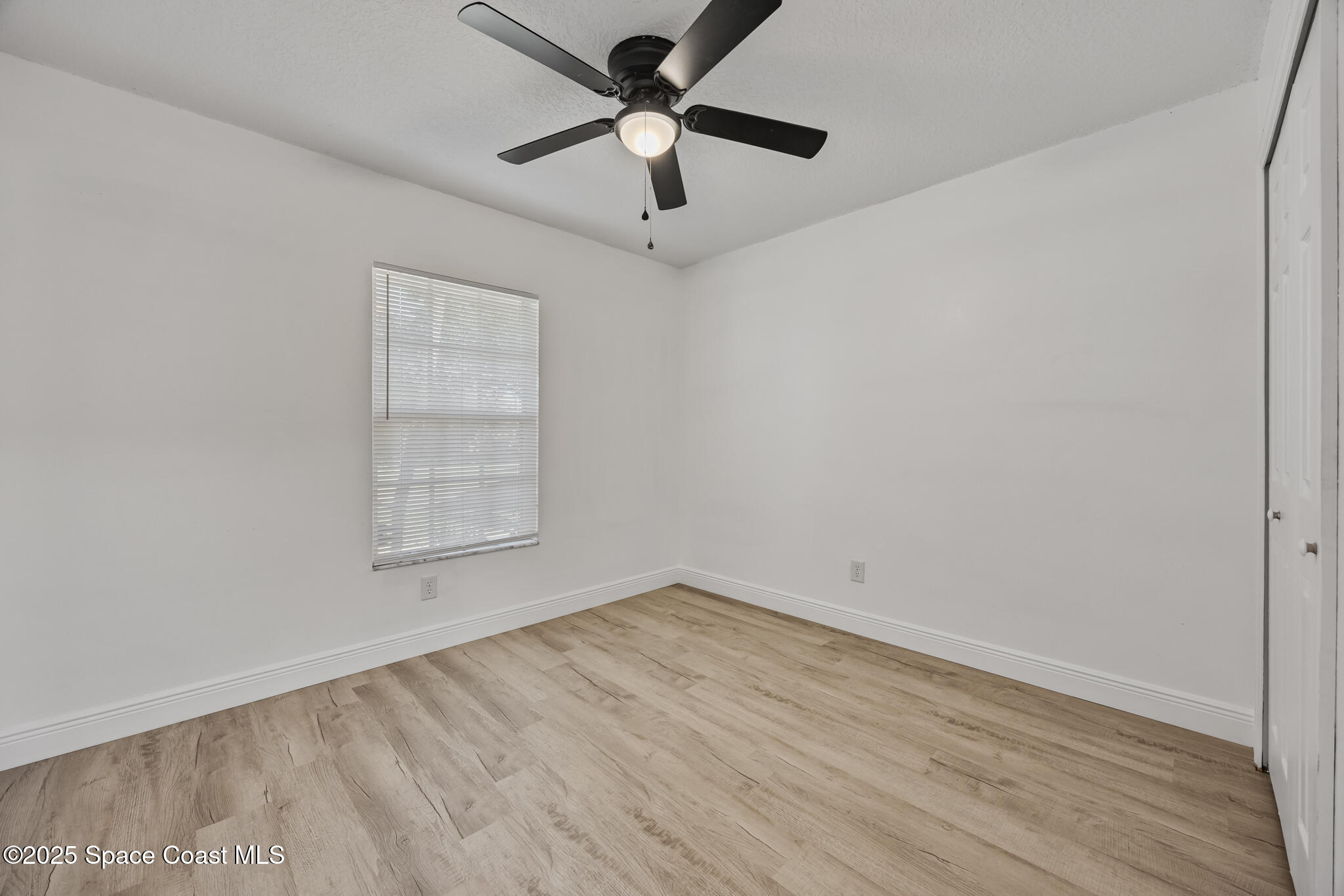 3568 Egret Drive Melbourne, FL 32901 - Photo 20 of 27 an empty room with a window and a ceiling fan