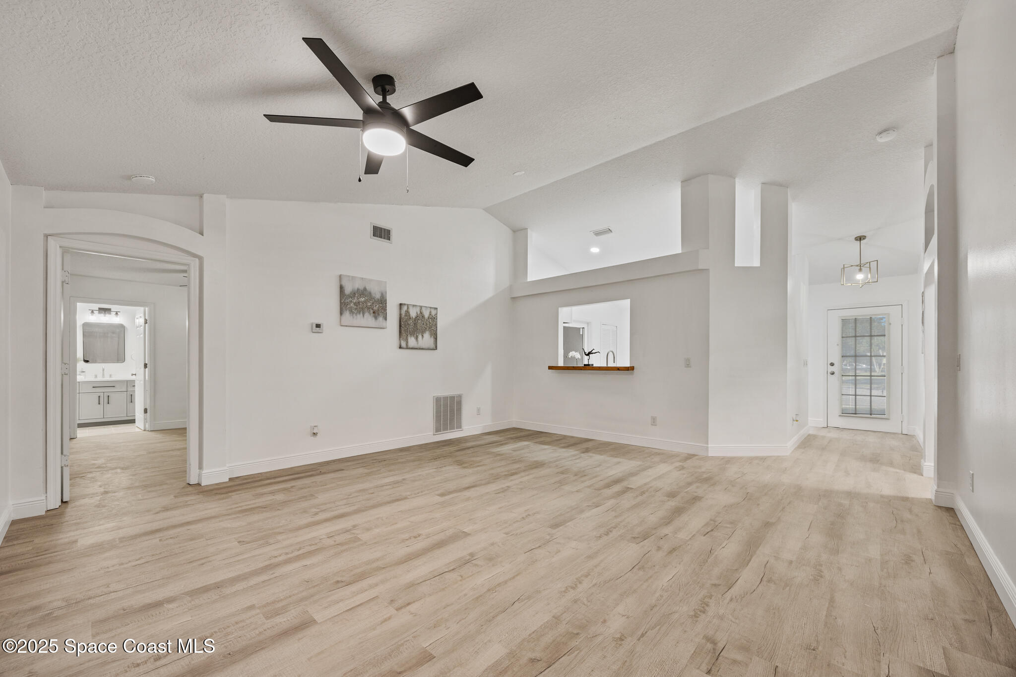 3568 Egret Drive Melbourne, FL 32901 - Photo 3 of 27 a view of empty room with wooden floor