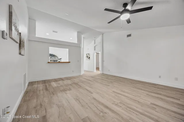 a view of empty room with wooden floor