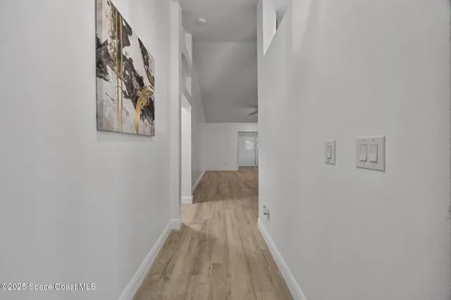 a view of an empty room with a ceiling fan