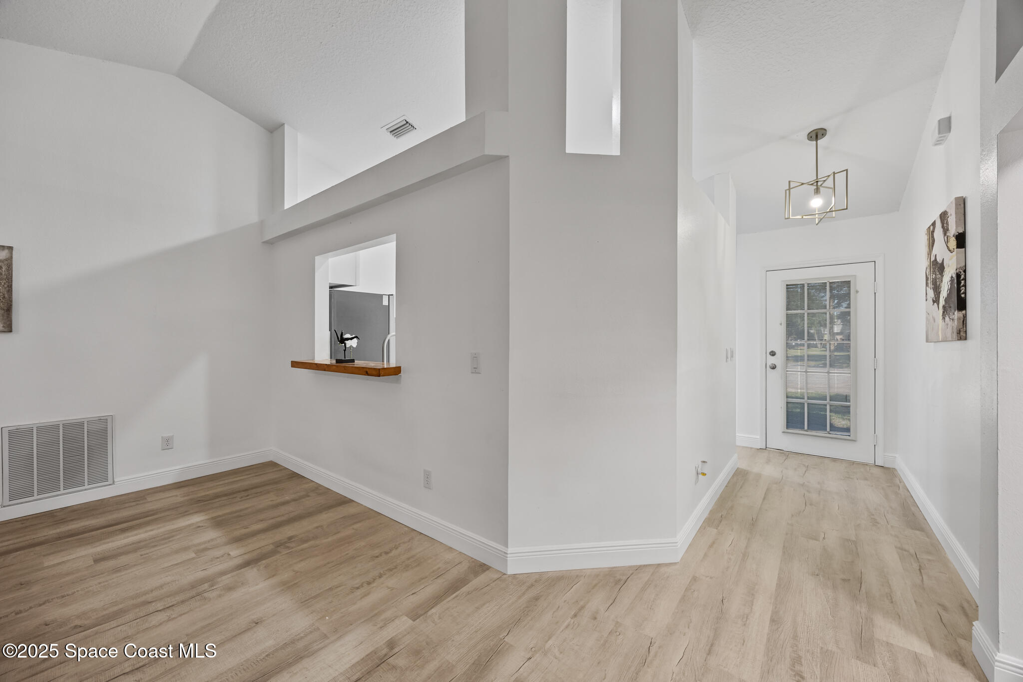 3568 Egret Drive Melbourne, FL 32901 - Photo 7 of 27 a view of empty room with wooden floor