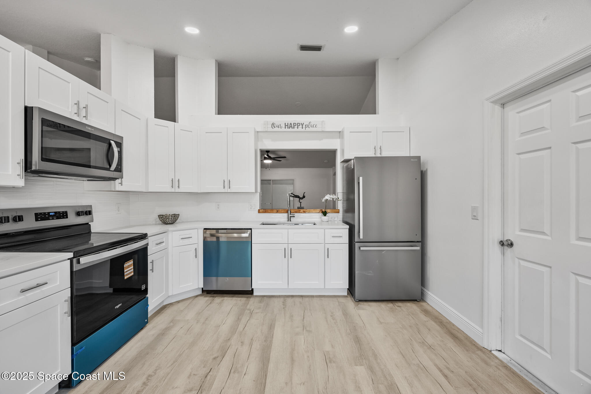 3568 Egret Drive Melbourne, FL 32901 - Photo 9 of 27 a kitchen with a sink a stove and refrigerator