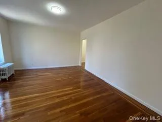 a view of room with wooden floor