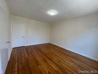 83-52 Talbot Street, Unit 3J Queens, NY 11415 - Photo 19 of 50 a view of empty room with wooden floor