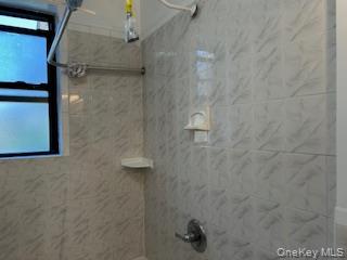 83-52 Talbot Street, Unit 3J Queens, NY 11415 - Photo 23 of 50 a bathroom with a shower
