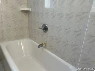 a bath tub sitting in a bathroom