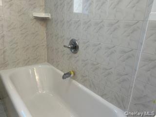 83-52 Talbot Street, Unit 3J Queens, NY 11415 - Photo 25 of 50 a bath tub sitting in a bathroom