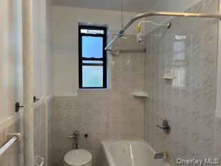 83-52 Talbot Street, Unit 3J Queens, NY 11415 - Photo 28 of 50 a bathroom with a shower and toilet