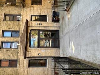 83-52 Talbot Street, Unit 3J Queens, NY 11415 - Photo 3 of 50 a view of a brick house with a door and a large window