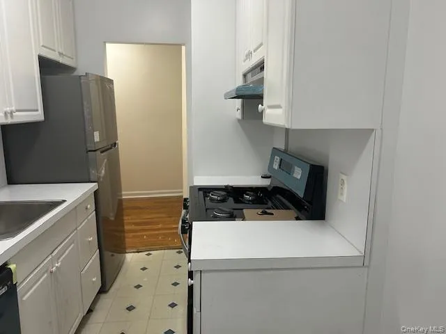 a kitchen with a stove and a refrigerator