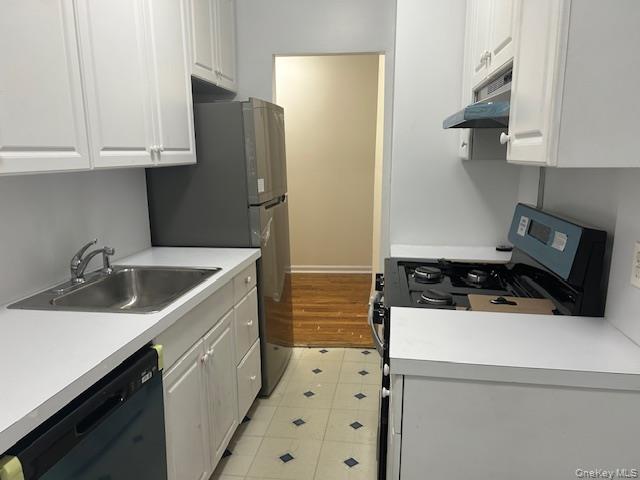 83-52 Talbot Street, Unit 3J Queens, NY 11415 - Photo 34 of 50 a kitchen with a sink a stove and refrigerator