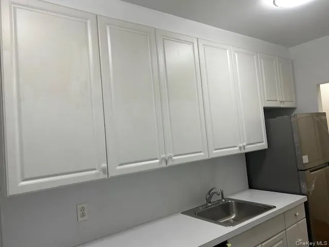 a kitchen with stainless steel appliances white cabinets and a sink