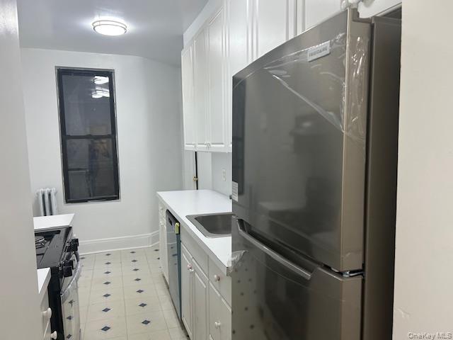 83-52 Talbot Street, Unit 3J Queens, NY 11415 - Photo 38 of 50 a bathroom with a shower sink and mirror