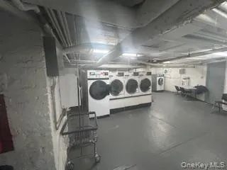 a utility room with multiple dryer and washer