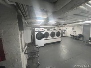 83-52 Talbot Street, Unit 3J Queens, NY 11415 - Photo 42 of 50 a utility room with multiple dryer and washer