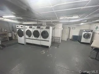 a utility room with stainless steel appliances granite countertop a stove and a refrigerator
