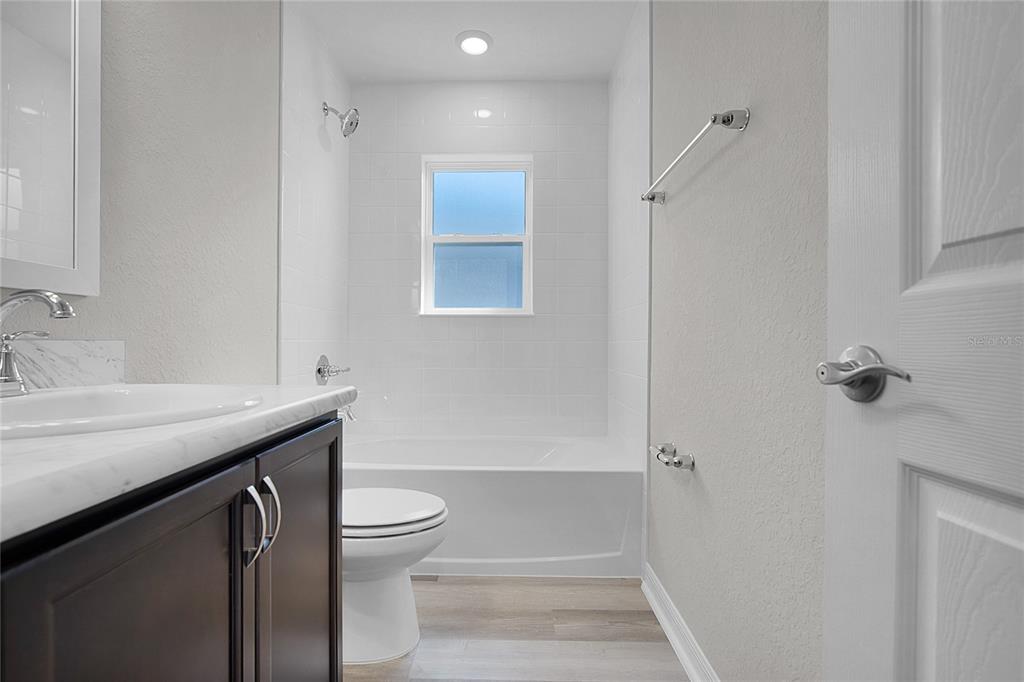 1617 Astrid Road Davenport, FL 33837 - Photo 12 of 43 a bathroom with a sink a toilet and shower