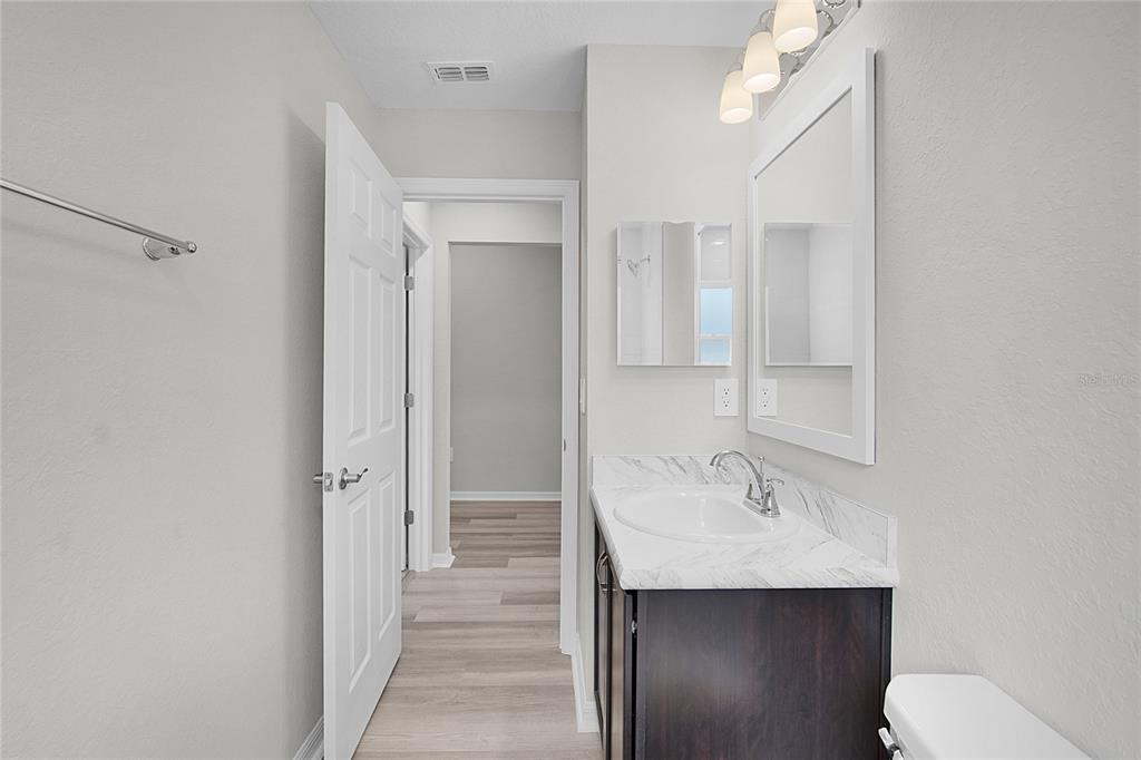 1617 Astrid Road Davenport, FL 33837 - Photo 13 of 43 a bathroom with a sink a toilet and shower