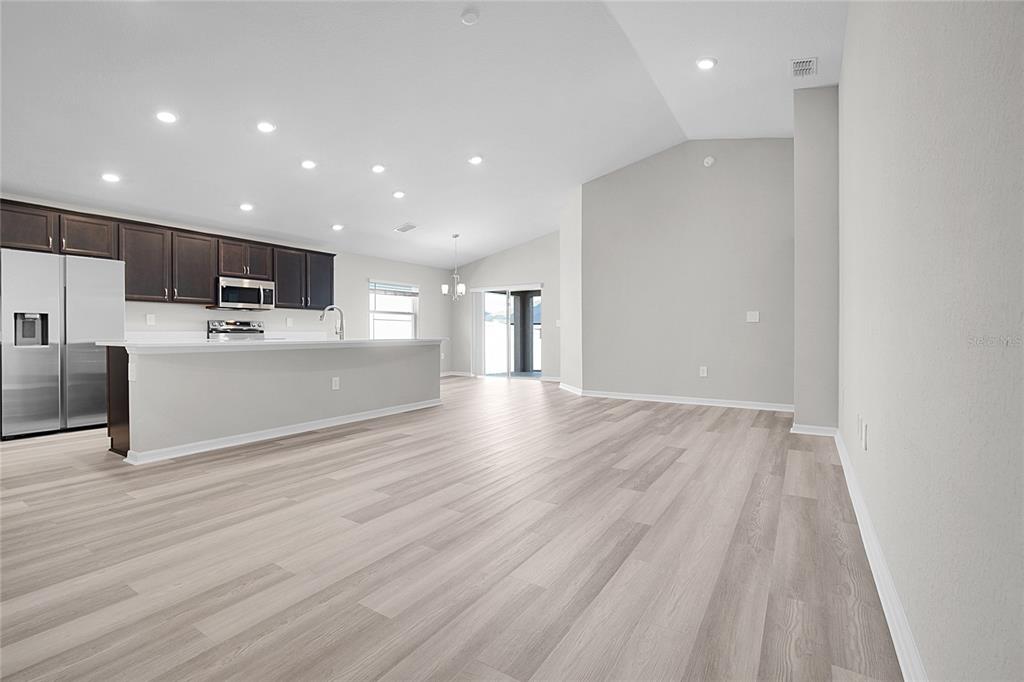 1617 Astrid Road Davenport, FL 33837 - Photo 16 of 43 a view of a big room with wooden floor and windows