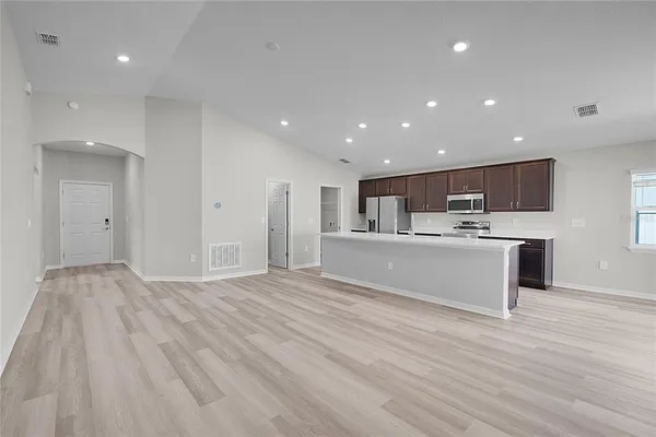 a view of wooden floor and windows in an empty room