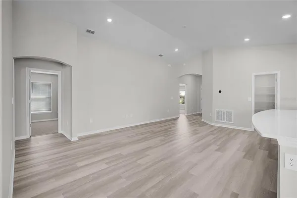 a large kitchen with stainless steel appliances kitchen island granite countertop a sink counter space and cabinets