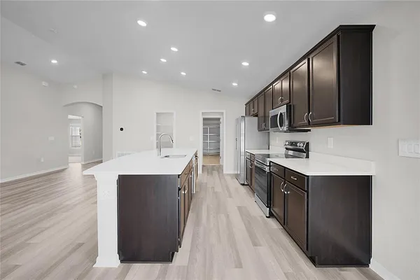 a kitchen with stainless steel appliances a sink stove and refrigerator